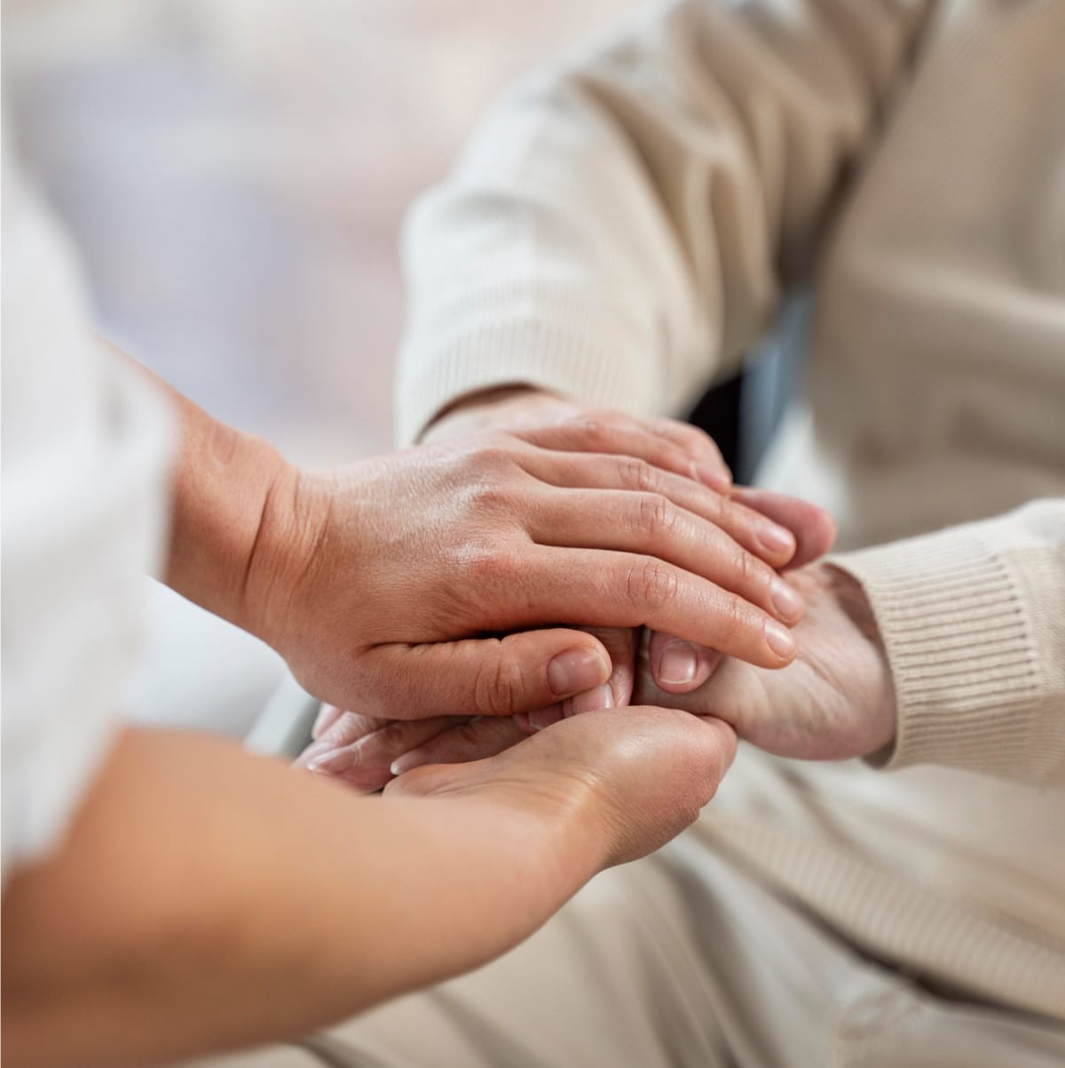 Stack of four hands, two younger, two older